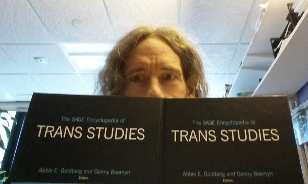 Genny looks over the top of The SAGE Encyclopedia of Trans Studies.